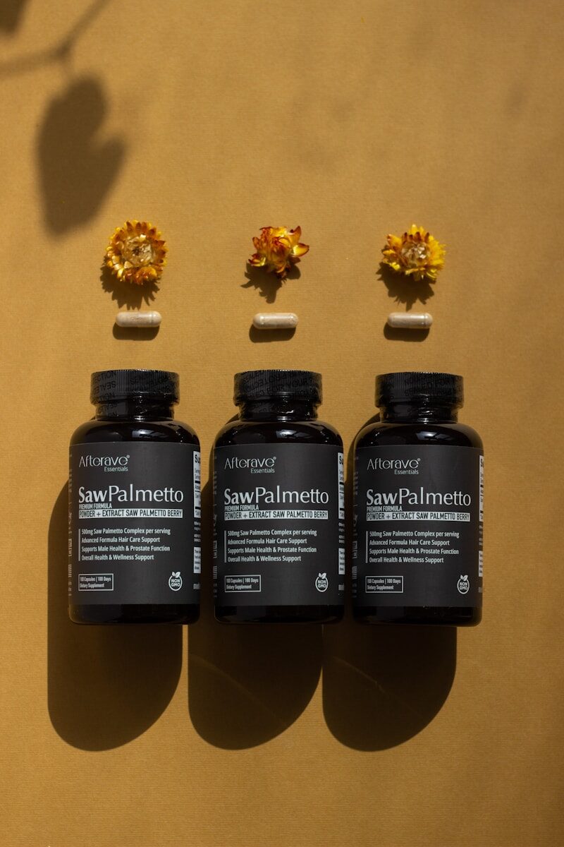 A group of three bottles of vitamins sitting on top of a table